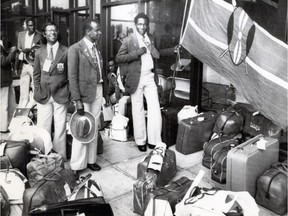 Kenyan athletes wait for a bus outside Olympic Village. They were on their way to the airport after their nation decided to boycott the 1976 Montreal Summer Olympic Games.