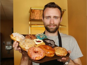 Lars Melby, of  Mighty Canadian Doughnuts on Barrydowne Road in Sudbury, Ont., shows a selection of donuts on Thursday June 2, 2016. John Lappa/Sudbury Star/Postmedia Network