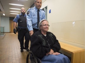 Former Lt. Governor Lise Thibault is escorted by special constables as she arrives at the courthouse on October 6, 2015 in Quebec City.