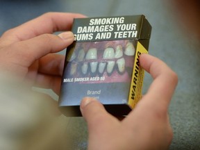 Local Ottawa high school students look at plain cigarette packaging examples, on World No Tobacco Day, prior to meeting with Minister of Health Jane Philpott in Ottawa on Tuesday, May 31, 2016. Philpott officially launched public consultations on plain packaging requirements for tobacco products.