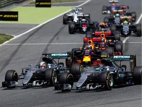 Mercedes drivers Lewis Hamilton of Britain, foreground left, and Nico Rosberg of Germany, foreground right, enter the first curve during the Spanish Formula One Grand Prix at the Barcelona Catalunya racetrack in Montmelo, just outside Barcelona, Spain, Sunday, May 15, 2016.