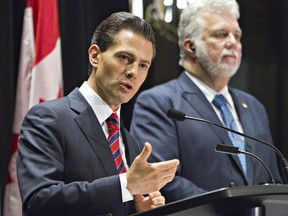 Mexican President Enrique Pena Nieto and Quebec Premier Philippe Couillard attend a press conference in Quebec City, Monday, June 27, 2016.