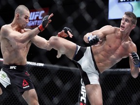 Stephen Thompson, right, kicks to the body of Rory MacDonald during UFC welterweight bout in Ottawa on Saturday June 18, 2016. Thompson won a unanimous decision over MacDonald in a battle of top welterweight contenders at UFC Fight Night 89 Saturday night. THE CANADIAN PRESS/Fred Chartrand ORG XMIT: FXC116