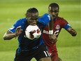 Montreal Impact forward Didier Drogba eyes the ball against Toronto FC defender Ashtone Morgan during second half of the Amway Canadian Championship game on Wednesday.