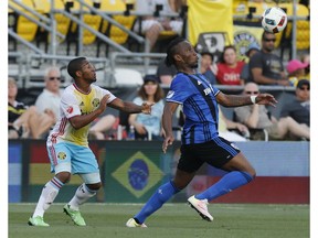 Montreal Impact forward Didier Drogba, right, keeps the ball away from Columbus Crew midfielder Tony Tchani during the first half of an MLS soccer match Saturday, June 18, 2016, in Columbus, Ohio.