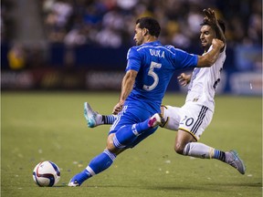 Montreal Impact midfielder Dilly Duka shoots against Los Angeles Galaxy defender A.J. DeLagarza during MLS game in Carson, Calif., on Sept. 12, 2015.