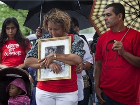 Lilian Villanueva, flanked by her husband Gilberto sheds a tear at a vigil commemorating the death of her son Fredy at the site where a memorial stands where he was shot and killed by a police officer,  in Montreal North , on Sunday August 8th 2010.