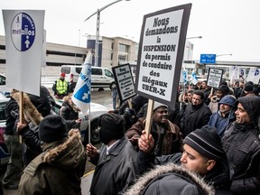 Montreal's taxi drivers stand in front of Trudeau airport to protest against Uber in 2016.