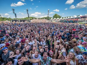 Music fans cheer before the performance by Ben Harper & The Innocent Criminals on the second day of the 2015 edition of the Osheaga music festival at Jean-Drapeau park.