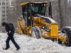 A grader clears snow on Peel St. in December.