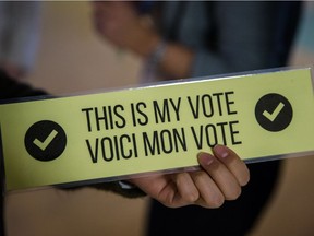 A student holds a voting card to be used for a BDS vote at McGill in February 2016. The movement has been a continuing source of tension on campus.