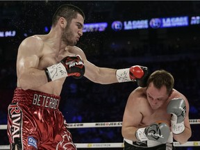 Artur Beterbiev, left, of Montreal connects  a punch against Gabriel Lecrosnier, right, of France during their light heavyweight division fight at the Bell Centre in Montreal on Saturday, January 18, 2014. Beterviev won by TKO.