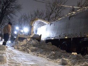 A snow removal crew clears the streets in the Mile End district of Montreal on Sunday January 3, 2016.