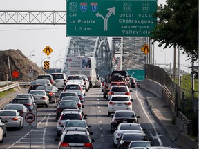 Cars line up to board the southbound Mercier Bridge in Montreal on Friday July 3, 2015.
