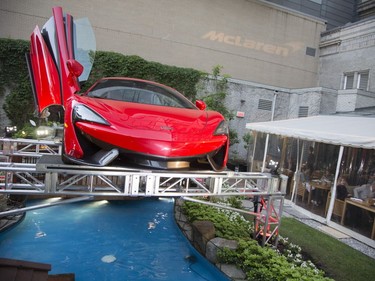 A car suspended in the garden  at a Grand Prix party at the Ritz Carlton in Montreal, Friday, June 10, 2016.