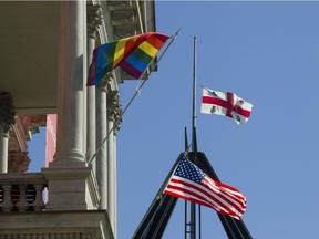 A rainbow flag and a U.S. flag fly outside Montreal city hall on Monday, June 13, 2016, a day after 49 people were shot dead at an Orlando gay club.