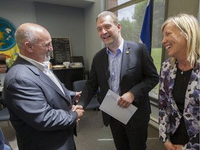 Vaudreuil-Dorion Mayor Guy Pilon, left, shares a joke with Quebec Minister of Culture and Communications, Luc Fortin and Vaudreuil MNA Marie-Claude Nichols, right, at the Vaudreuil-Dorion library on Monday. They announced plans to expand the library and that the provincial government would contribute $3 million.