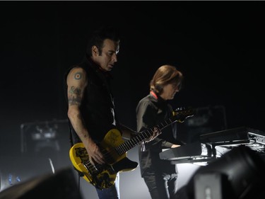 Bass guitarist Simon Gallup, left, and Roger O'Donnell at the keyboards, right, from The Cure in performance at the Bell Centre on June 14, 2016.