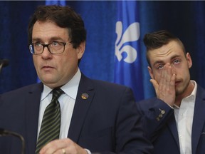 Marie-Victorin MNA Bernard Drainville and his son Lambert at a news conference announcing that the Parti Québecois stalwart is leaving politics to take up a radio career.