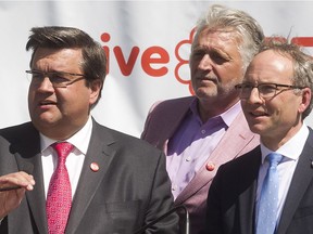 Montreal mayor Denis Coderre, left, with Gilbert Rozon, centre, Commissioner for the 375th, and Martin Coiteux, Quebec Minister of Municipal Affairs, listen to questions during public unveiling of plans for neighbourhood projects for the 375th anniversary, held in east end Montreal  on Tuesday June 14, 2016.