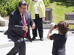 Montreal mayor Denis Coderre, left, with Gilbert Rozon, centre, Commissioner for the 375th, and Martin Coiteux, Quebec Minister of Municipal Affairs, listens to questions during public unveiling of plans for neighbourhood projects for the 375th anniversary.