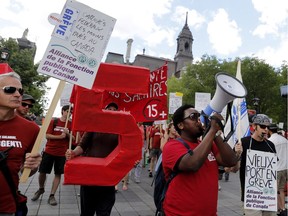 Striking Old Port of Montreal workers march along Place Jacques-Cartier in Montreal June 15, 2016.