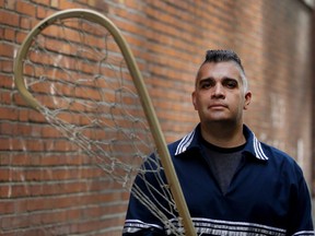 Travis Gabriel displays one of his handmade lacrosse sticks in Montreal on Wednesday June 15, 2016. Gabriel still makes lacrosse sticks the old-fashioned way in the Mohawk tradition. He is holding a stick that was used during the 1860 to late 1870s period.