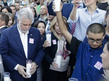 Esteban Torres Wicttorff, right, moments before he attempted an assault on Quebec Premier Philippe Couillard, left, during a vigil on June 16, 2016 at Parc de l'Espoir in Montreal to honour the victims of an attack at a nightclub in Orlando, Florida.