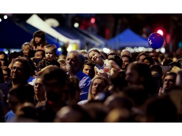 MONTREAL, QUE.: JUNE 24, 2016-- A little girls smiles as she rides above the heads of the crowd to listen to Yann Perreau perform during the fete national dans Villeray in Montreal on Friday June 24, 2016. (Allen McInnis / MONTREAL GAZETTE) ORG XMIT: 56544