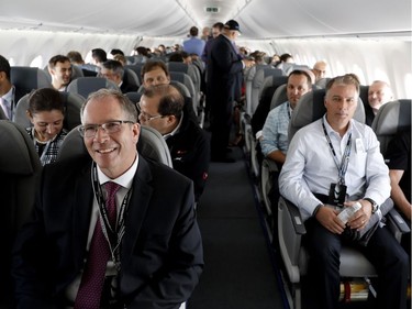 Bob Dewar, left, vice president C Series at Bombardier Aerospace, sits in the first row during a media flight in the first CS 100 to be delivered by Bombardier in Montreal on Wednesday June 29, 2016.