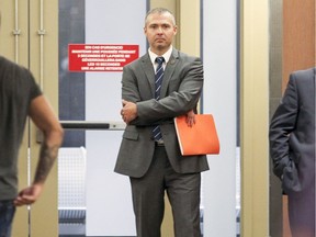Montreal Police Sgt. Marc-Andre Dube waits outside the courtroom to testify in the murder trial of Richard Henry Bain. Bain is accused of shooting a stagehand outside the Metropolis night club on September 4, 2012, while the Parti Quebecois were celebrating their provincial election victory.