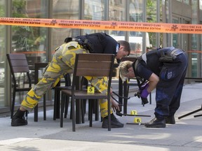 Police investigate the scene of a fight outside a Tim Horton's café in downtown Montreal, June 3, 2016.