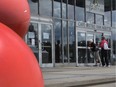 Two women look inside the Montreal Science Centre in the Old Port to find out why the doors are locked on June 7, 2016.  A strike by nearly 280 federal employees has led to the closure of the science centre, as well as the Clock Tower Beach and Port d’Escale marina.