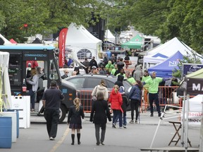 Pedestrians walk down the centre of the street on the first day of the Monkland street festival in Montreal Thursday June 9, 2016.  Monkland Hardware has a petition against the street fest, which takes place twice each year.
