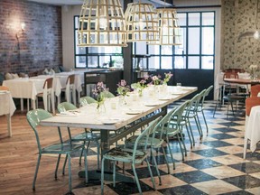 Chambre à Part's decor is whimsical, with mismatched chairs, exposed brick walls and a large communal table.