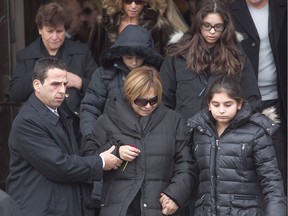 Francesca Montagna, wife of Salvatore Montagna walks out of Notre-Dame-de-Pompéi church with their children Nov. 28, 2011. Montagna was shot dead in Charlemagne.