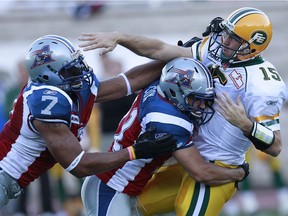 Despite being wily veterans, Chip Cox and John Bowman, seen here  tackling QB Ricky Ray in 2010, never take anything for granted when it comes to making the Als' roster.