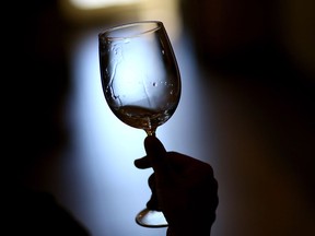 NAPA, CA - AUGUST 26: A visitor holds a glass of wine while tasting at Madonna Estate Winery on August 26, 2014 in Napa, California. Two days after a 6.0 magnitude earthquake rocked the Napa Valley, residents and wineries are continuing clean up operations and slowly reopening their doors to customers.