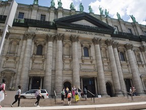 People enter Marie Queen of the world cathedral, Thursday, June 23, 2016 in Montreal. The Catholic Church of Montreal plans to bar priests, volunteers and all those involved in faith education from being alone with children later this year.