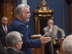 Quebec Premier Philippe Couillard defends his Transport Minister Jacques Daoust as he responds to the Opposition on the Rona deal, June 3, 2016, at the legislature in Quebec City.