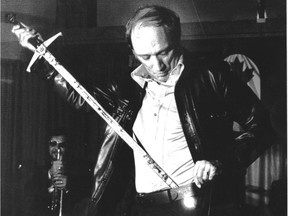 Prime Minister Pierre Trudeau tries on a sword presented to him by the Canadian Olympic Association in Montreal in July 1976. The COA presented 26 swords to various persons associated with the Games and their organizations during a reception for the Canadian Olympic team.