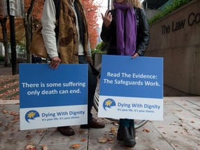 Assisted-suicide supporters wait outside the B.C. Court of Appeal before the court overturned a lower court ruling that said Canada's assisted-suicide ban violated the charter rights of gravely ill Canadians, in Vancouver, B.C., on Thursday October 10, 2013.