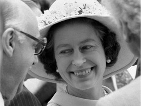 Queen Elizabeth II flashes a smile for Montreal Mayor Jean Drapeau at a reception at Montreal city hall July 17, 1976. The Queen opened the Olympics later that afternoon.