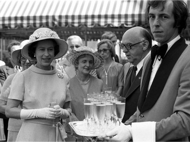 Queen Elizabeth II stands with Montreal Mayor Jean Drapeau at a reception at Montreal city hall July 17, 1976. The Queen will open the Olympics later that afternoon.