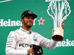 Lewis Hamilton of Great Britain and Mercedes GP celebrates his win on the podium during the Canadian Formula One Grand Prix at Circuit Gilles Villeneuve on June 12, 2016, in Montreal.