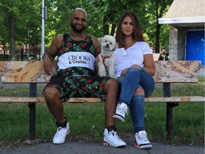 Riley the miniature poodle, Tyler Haynes and Yasmin del Buey enjoy a breezy, shady moment on a bench in Vinet Park.