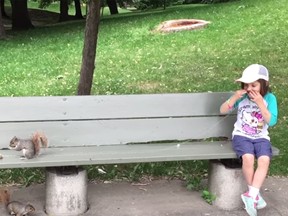 David Freiheit's daughter Mila waits for a squirrel to make off with a granola bar, subsequently pulling out her tooth.