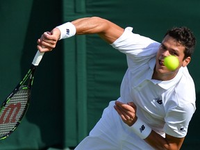 Thornhill, Ont's Milos Raonic serves against Spain's Pablo Carreno Busta during their men's singles first round match at Wimbledon on Monday, June 27, 2016.