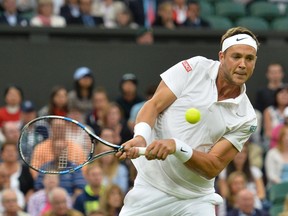 Britain's Marcus Willis returns against Switzerland's Roger Federer in their men's singles second round match at Wimbledon on June 29, 2016.