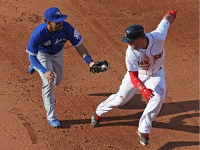 Travis Shaw of the Boston Red Sox gets caught in a run down by Devon Travis of the Toronto Blue Jays in the fifth inning during the game at Fenway Park on June 4, 2016, in Boston.